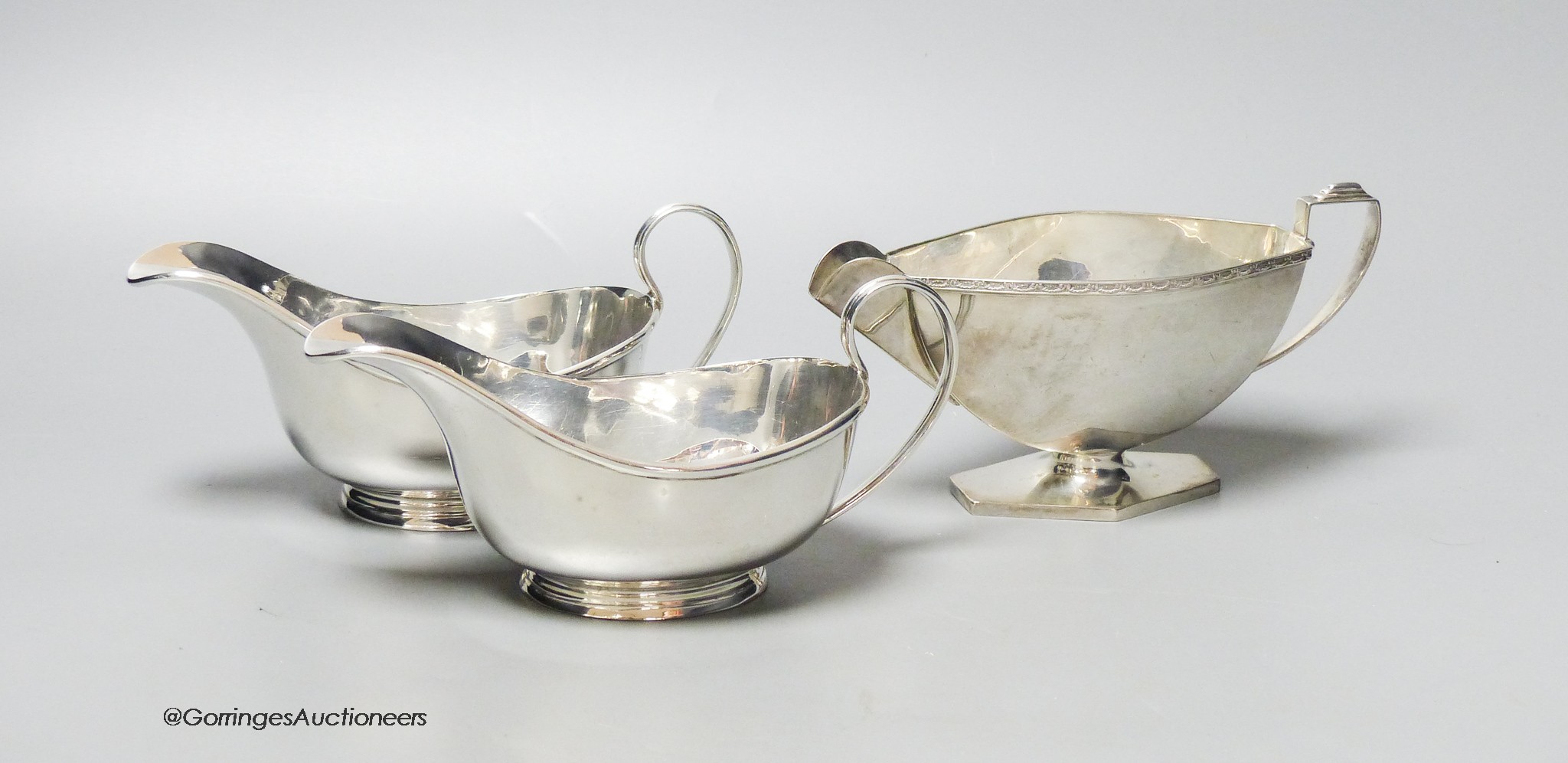 A pair of George V silver sauceboats, London, 1928 and one other silver sauceboat, 14oz.